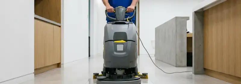 Janitorial staff using a floor scrubber machine to clean a commercial hallway, Dayton, OH.